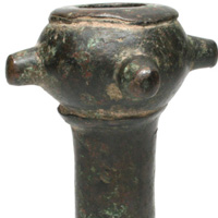 This is another example of a Lorestan bronze mace head. Lorestan comprises a province and a historic territory of western Iran amidst the Zagros Mountains. This mace has four radial spikes protruding from the head. The socket is hollow and slightly flared near the bottom. It is not quite as old as the next example and was most likely made by the Medes-Persian during the early Iranian iron age of 1250-650 BC.<a class="macecolorred" href="../images/maces/Loristan2.jpg">Click Here to see a larger version of this image.</a>