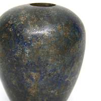 This is one of the earliest style of maces. It is known as a "piriform" which means pear shaped. This particular example is made of lapis lazuli and was probably a ceremonial mace rather than one used in battle. This replaced the earlier disc mace which was prone to breaking. This style began to be used throughout the Naqada III period of 3250 to 3100 BC. A lot of Egyptian wall carvings in temples and other monuments show Pharaohs smiting enemies with maces even years after their popularity had diminished. <a href="../images/maces/seti_mace.jpg">Here is a link to an image of an example of Seti I using a similar style mace.</a><a class="macecolorred" href="../images/maces/egyptian.jpg">Click Here to see a larger version of this image.</a>